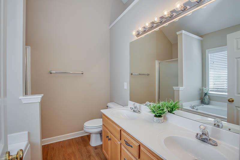 2242 Dewey Drive Spring Hill, TN 37174 - Photo 17 of 29 a bathroom with a granite countertop sink a toilet and a mirror
