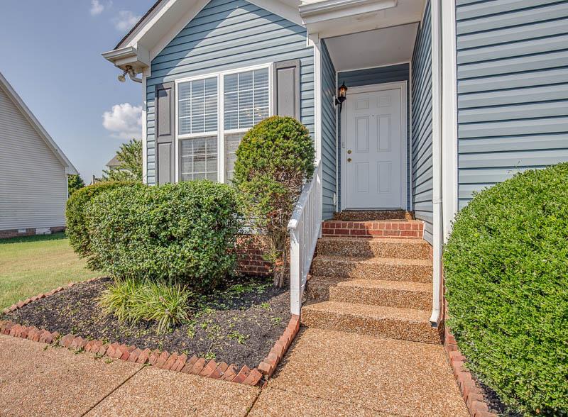 2242 Dewey Drive Spring Hill, TN 37174 - Photo 2 of 29 a front view of a house with garden