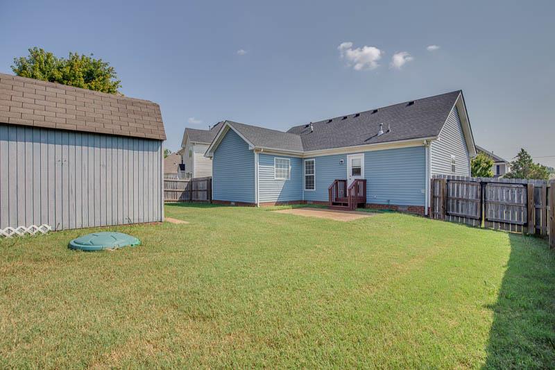 2242 Dewey Drive Spring Hill, TN 37174 - Photo 27 of 29 a bedroom with a bed and a table