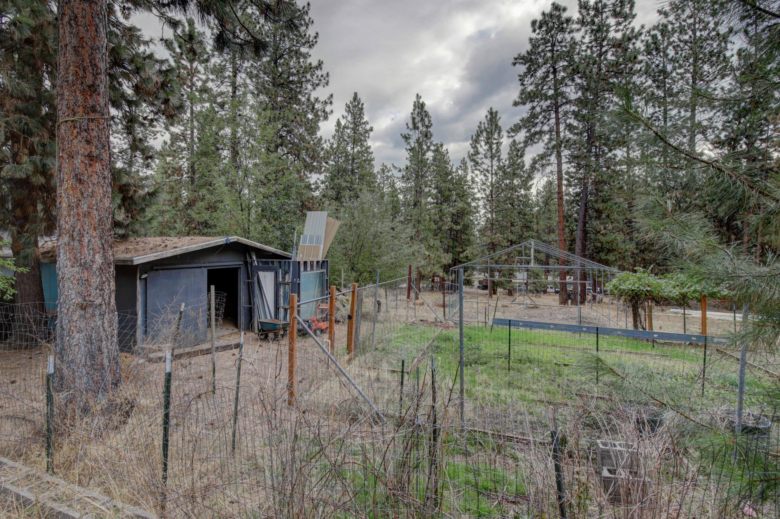 60184 Crater Road Bend, OR 97702 - Photo 23 of 29 Property has had a large garden, which is mostly still fenced and includes fruit trees. There is also the frame of a substantial greenhouse, a chicken coop, and a storage shed.