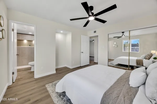 a bedroom with a bed and a large mirror