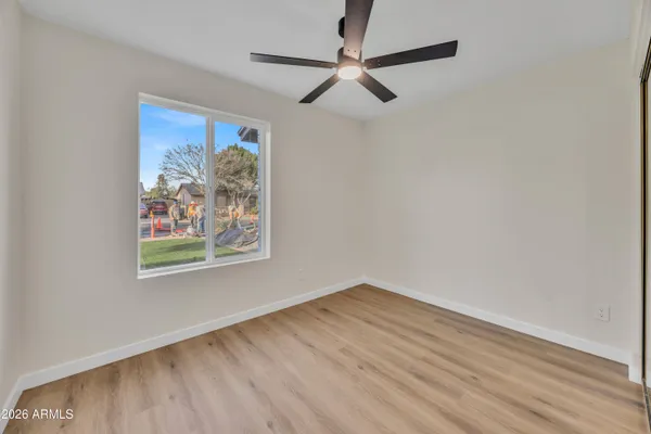 a view of a hallway with wooden floor and a window