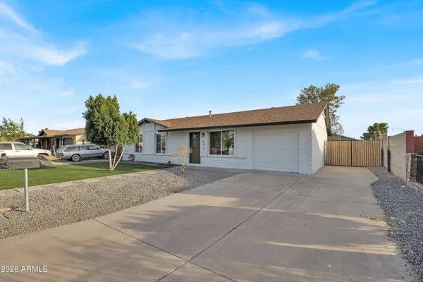 a view of a house with a backyard