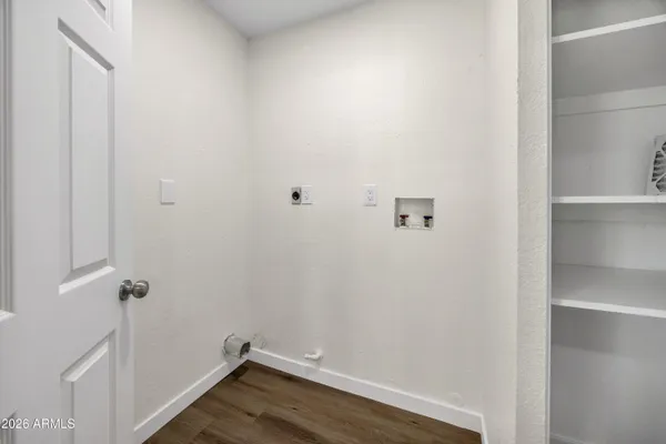 a view of a room with wooden floor