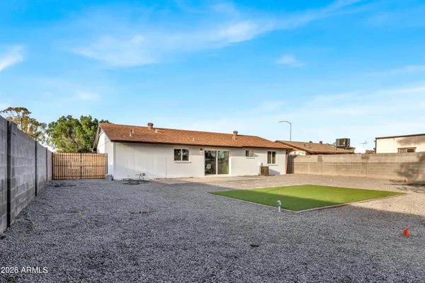 a view of a house with a yard and potted plants