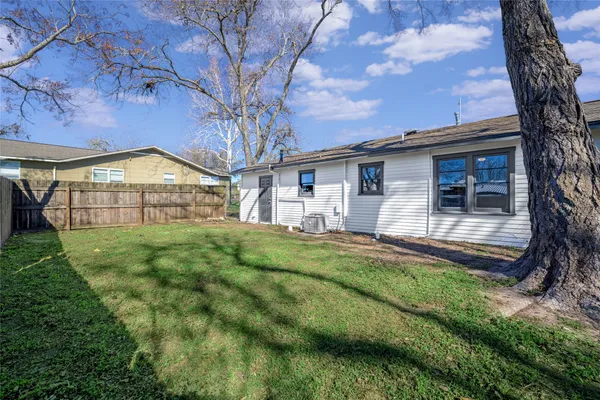 a view of a house with a backyard