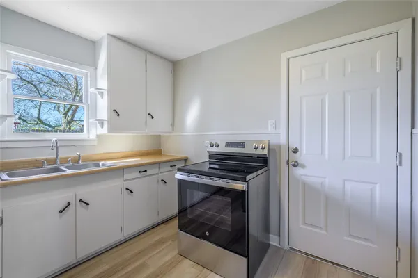 a kitchen with a sink stove and cabinets