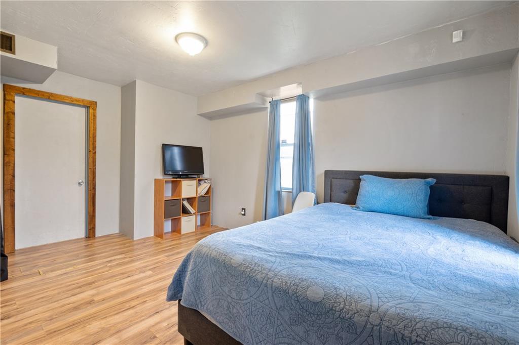 197 William Street McKees Rocks, PA 15136 - Photo 21 of 25 a bedroom with a bed and a flat screen tv