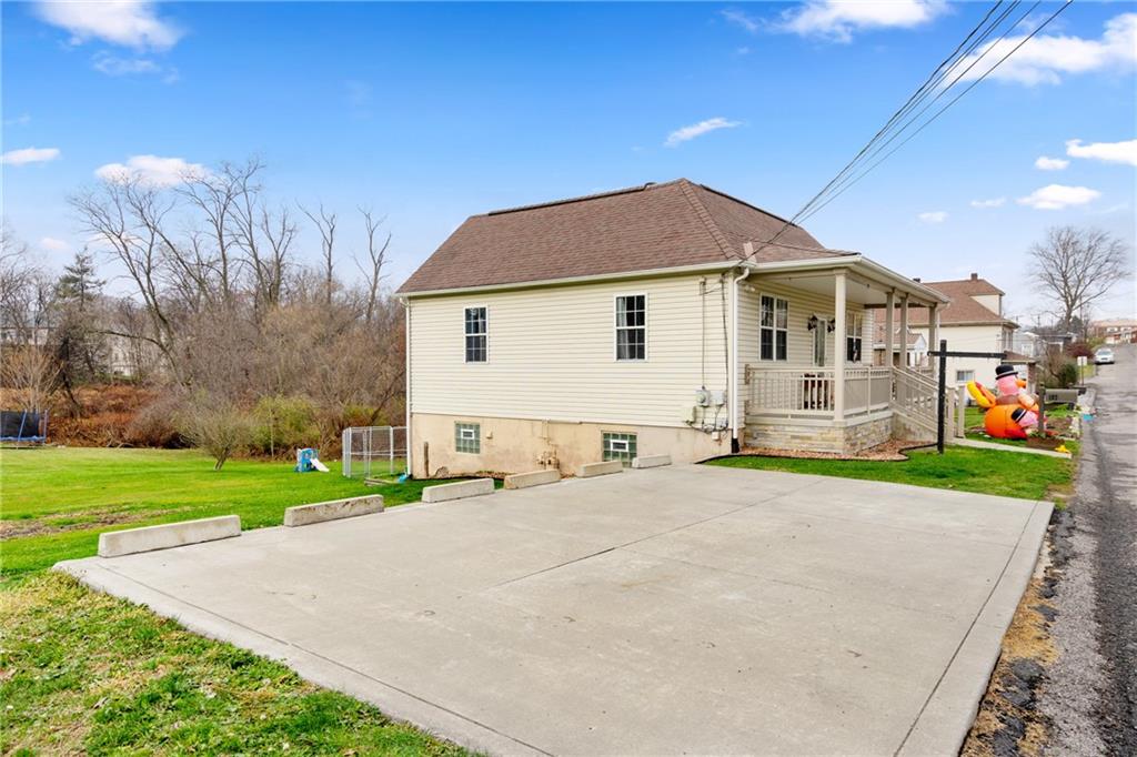 197 William Street McKees Rocks, PA 15136 - Photo 3 of 25 a front view of a house with a yard and garage