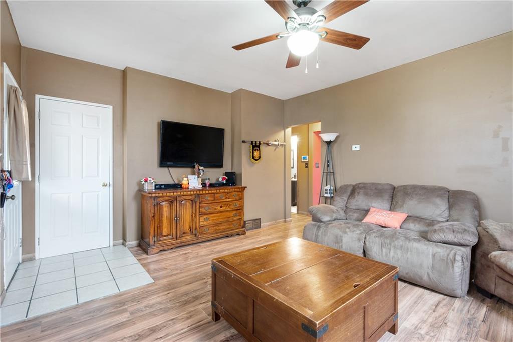 197 William Street McKees Rocks, PA 15136 - Photo 7 of 25 a living room with furniture and a flat screen tv