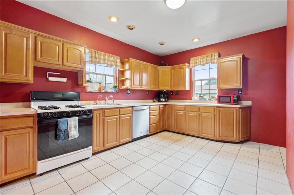 197 William Street McKees Rocks, PA 15136 - Photo 9 of 25 a kitchen with a stove a sink dishwasher and a refrigerator