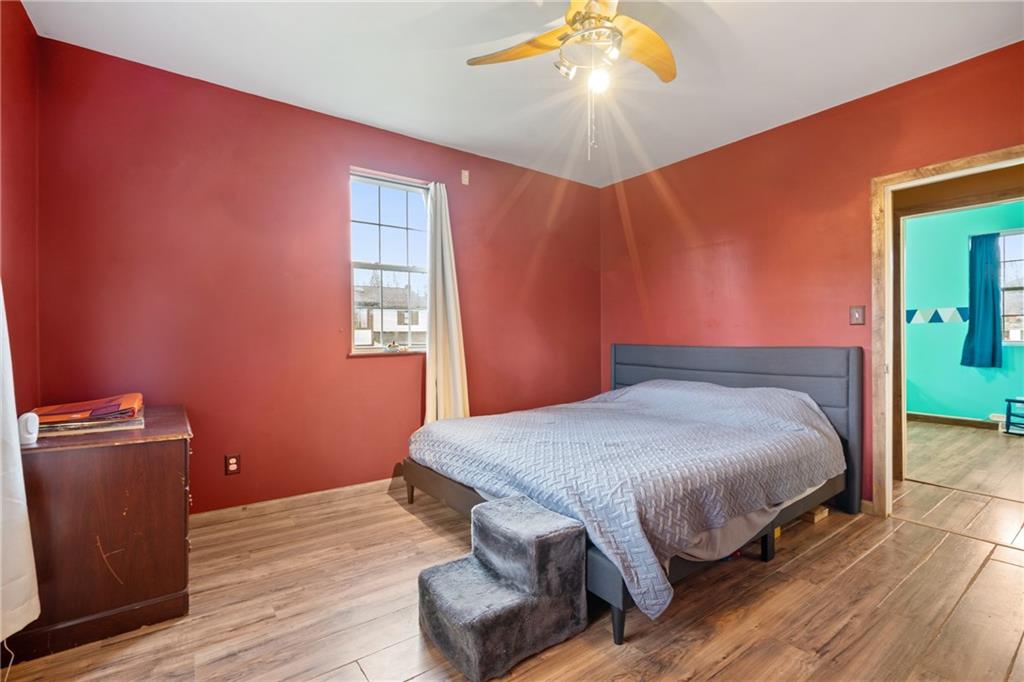 197 William Street McKees Rocks, PA 15136 - Photo 10 of 25 a bedroom with a bed and a chandelier