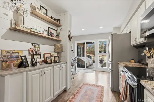 a kitchen with stainless steel appliances granite countertop a sink and cabinets