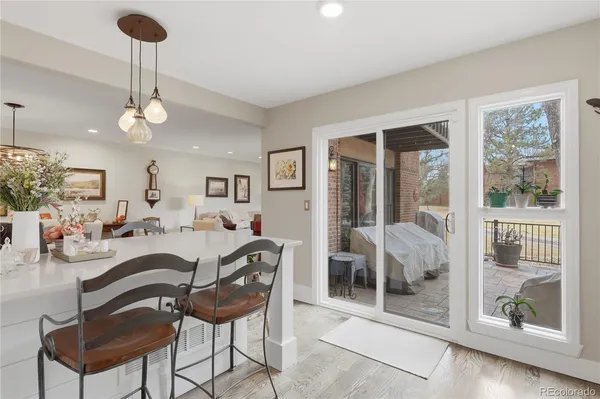 a living room with furniture a chandelier and a window