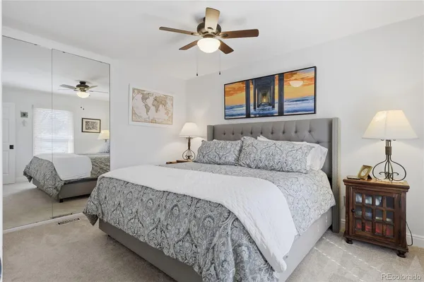 a bedroom with a bed and a lamp
