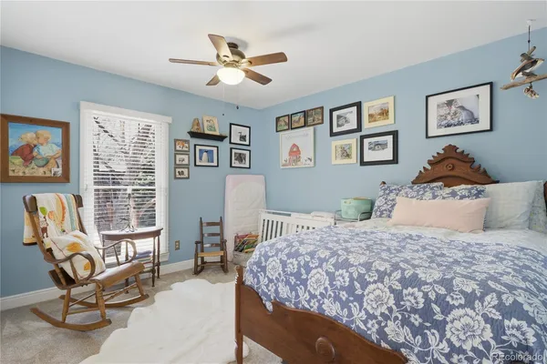 a bedroom with a bed a couch and a window