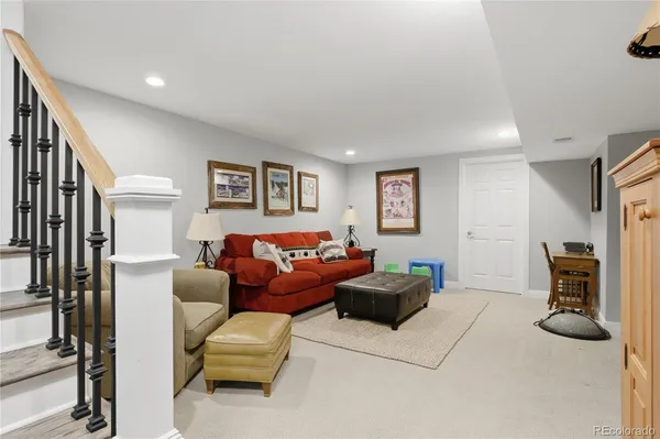 a living room with furniture and a cabinet