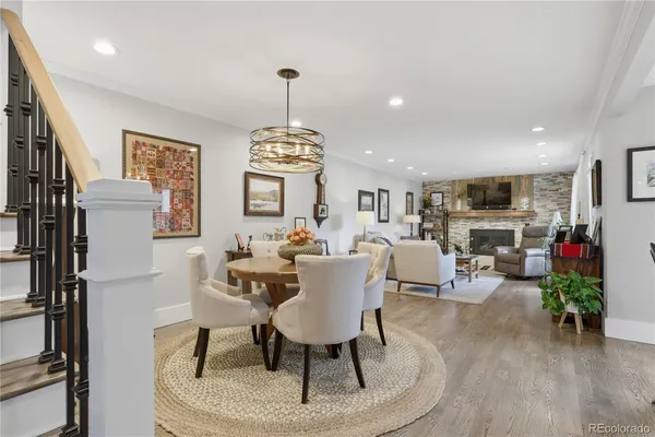 a view of a livingroom with furniture a fireplace and wooden floor