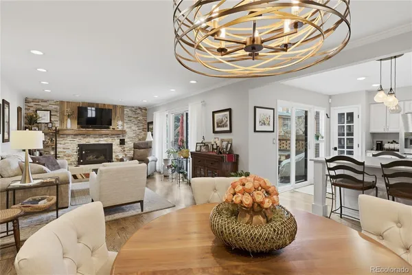 a living room with furniture a fireplace and a chandelier