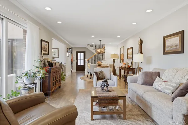 a living room with furniture and wooden floor