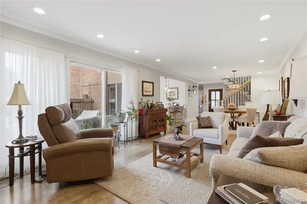 a living room with furniture wooden floor and a large window