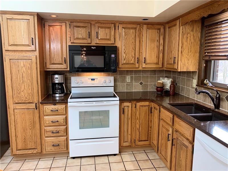 3241 Ridgeway Road Greensburg, PA 15601 - Photo 2 of 25 Oak kitchen with of storage with quartz counter tops and tiled back splash