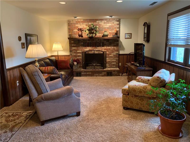 3241 Ridgeway Road Greensburg, PA 15601 - Photo 19 of 25 Family room with bricked gas fireplace, neutrally painted walls and flooring.