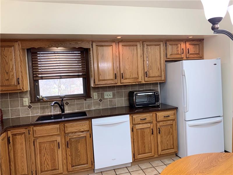 3241 Ridgeway Road Greensburg, PA 15601 - Photo 3 of 25 Oak eat in kitchen with tiled back splash and quartz counter tops