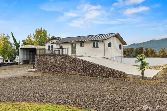 a view of a house with backyard and sitting area