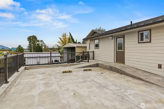 a view of a lake with a big yard and large trees