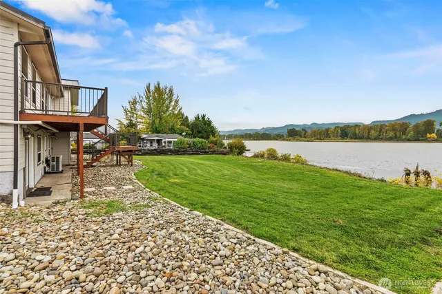 a view of a lake with houses in the back