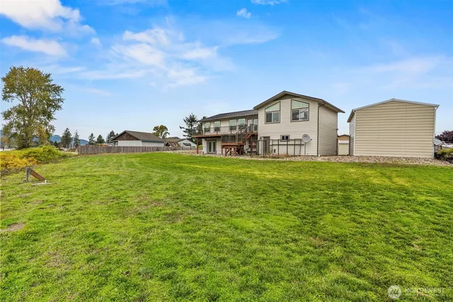 a view of balcony with wooden floor and fence