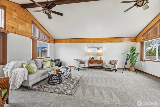 a living room with furniture a wooden floor and a large window