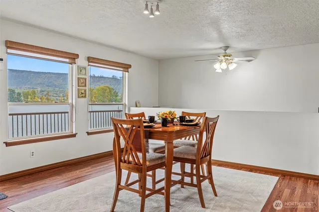 a kitchen with granite countertop stainless steel appliances a refrigerator cabinets and wooden floor
