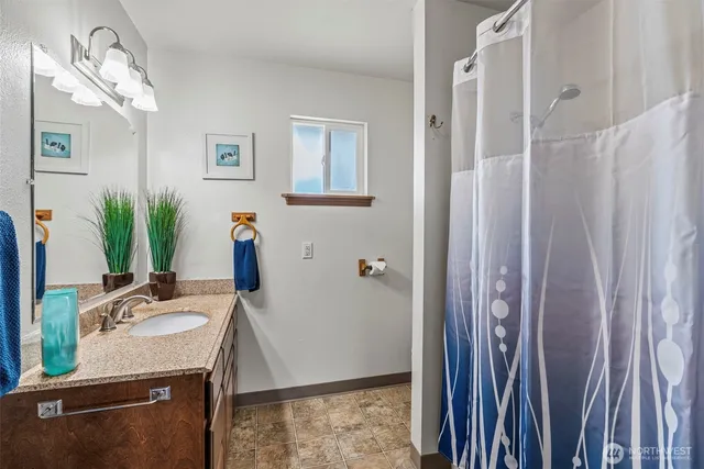 a view of kitchen with granite countertop cabinets