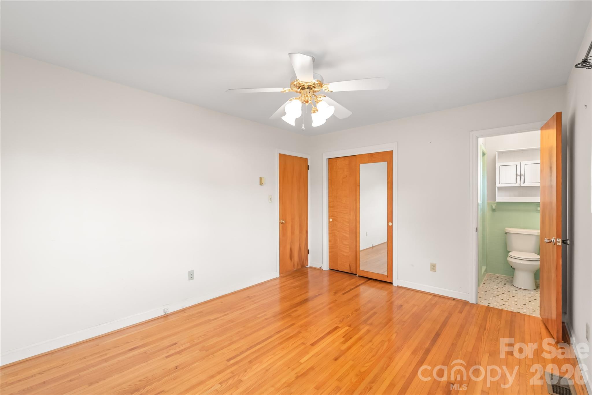 105 West Sunset Drive Locust, NC 28097 - Photo 13 of 24 wooden floor in an empty room with a window