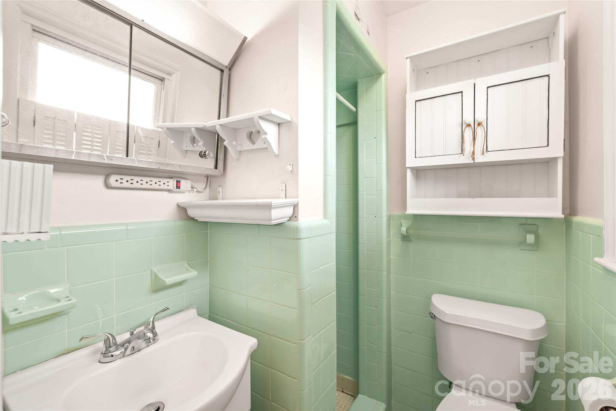 105 West Sunset Drive Locust, NC 28097 - Photo 14 of 24 a bathroom with a sink and mirror with toilet