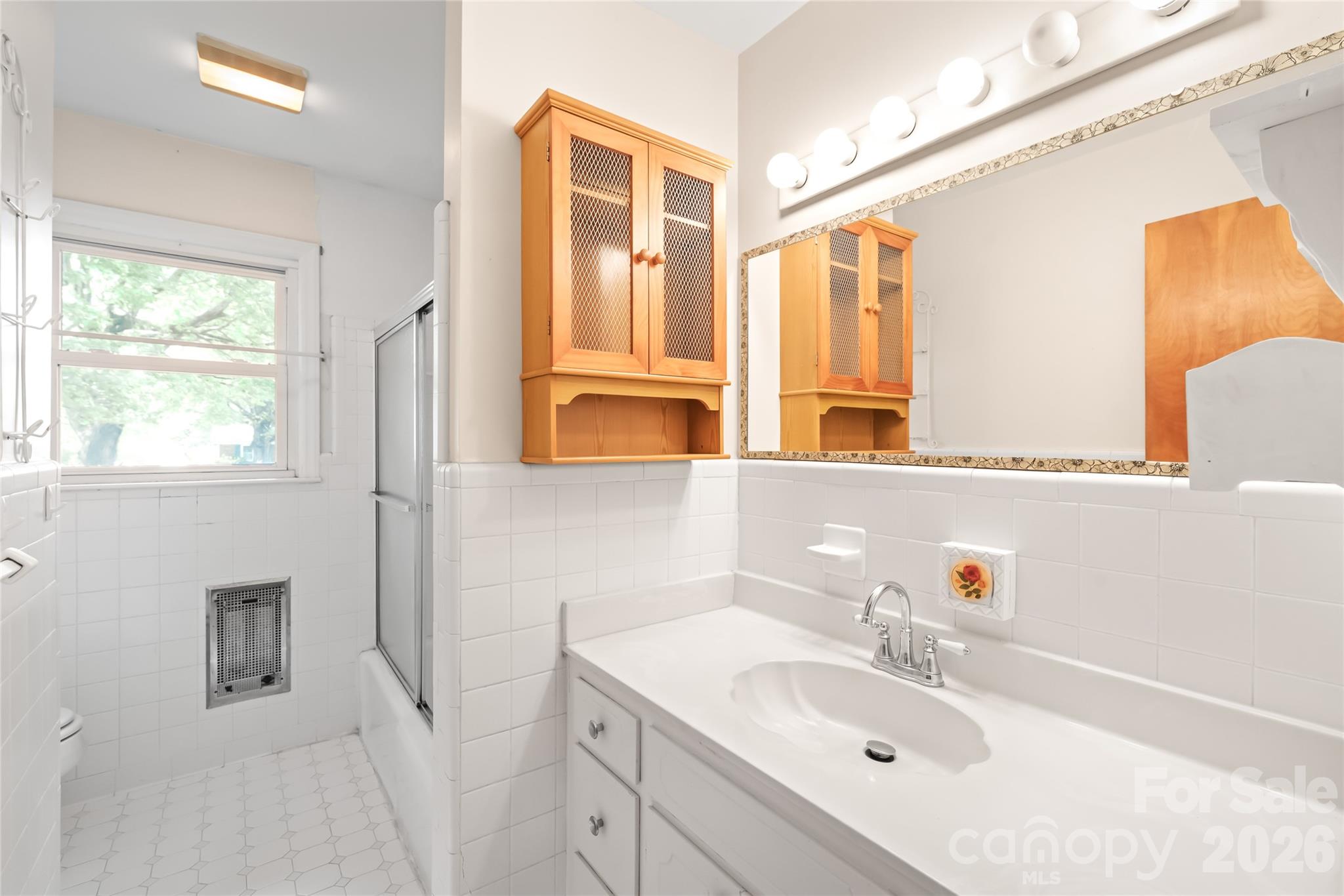 105 West Sunset Drive Locust, NC 28097 - Photo 18 of 24 a bathroom with a sink and a mirror