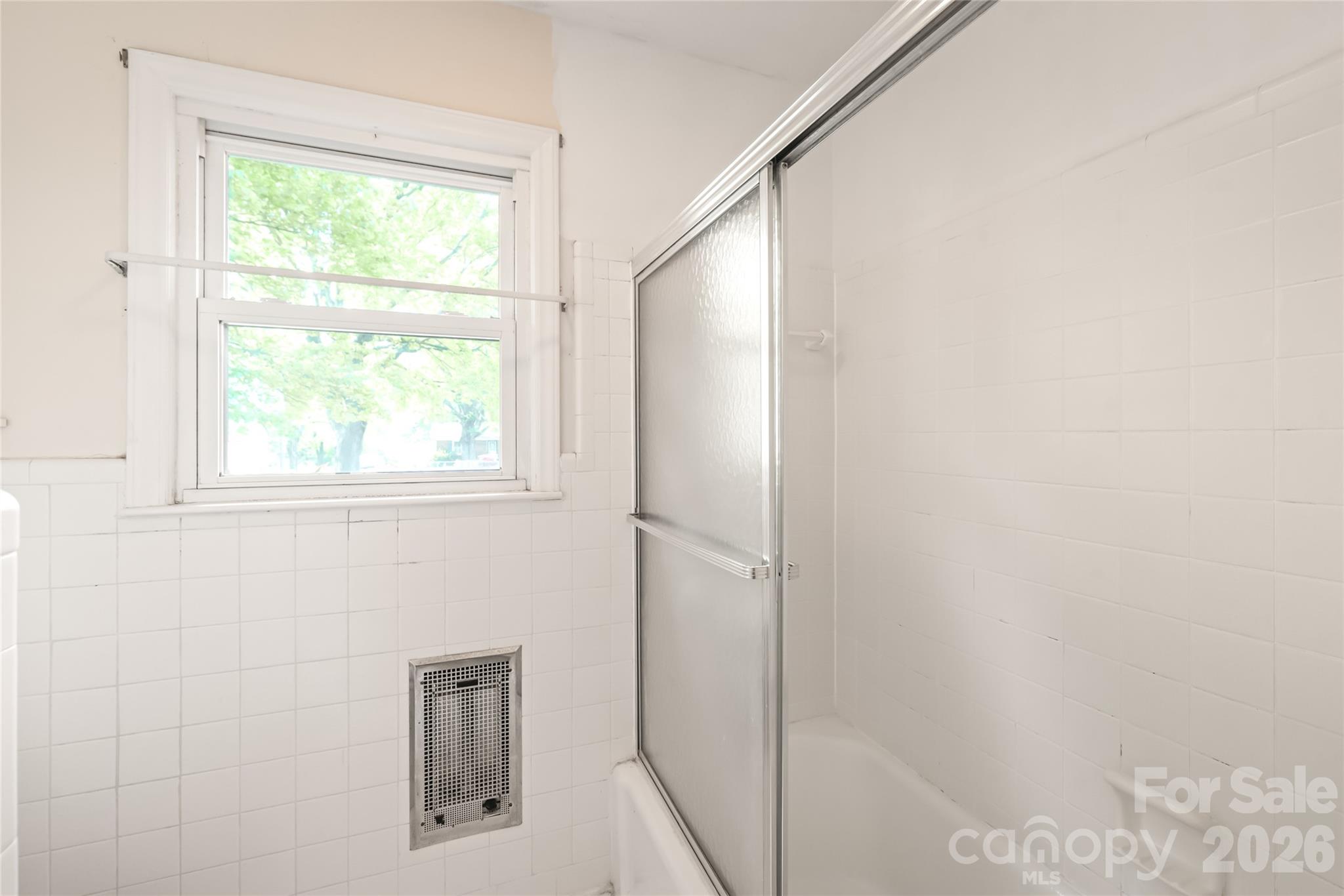 105 West Sunset Drive Locust, NC 28097 - Photo 19 of 24 a bathroom with a window and a shower
