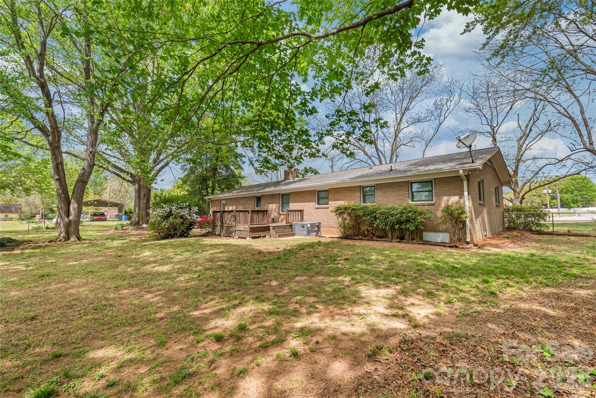 105 West Sunset Drive Locust, NC 28097 - Photo 22 of 24 a front view of house with yard and green space