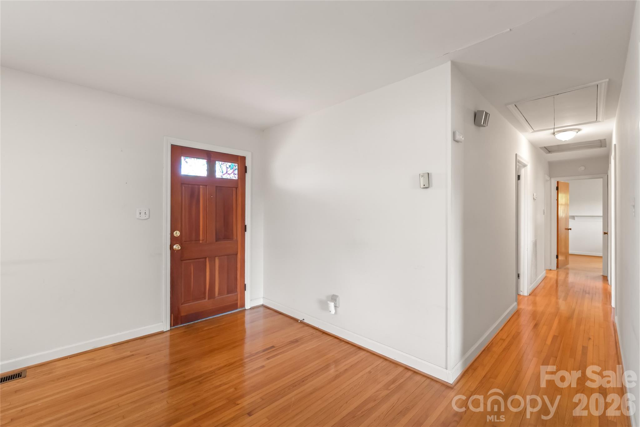 105 West Sunset Drive Locust, NC 28097 - Photo 3 of 24 a view of a hallway with wooden floor