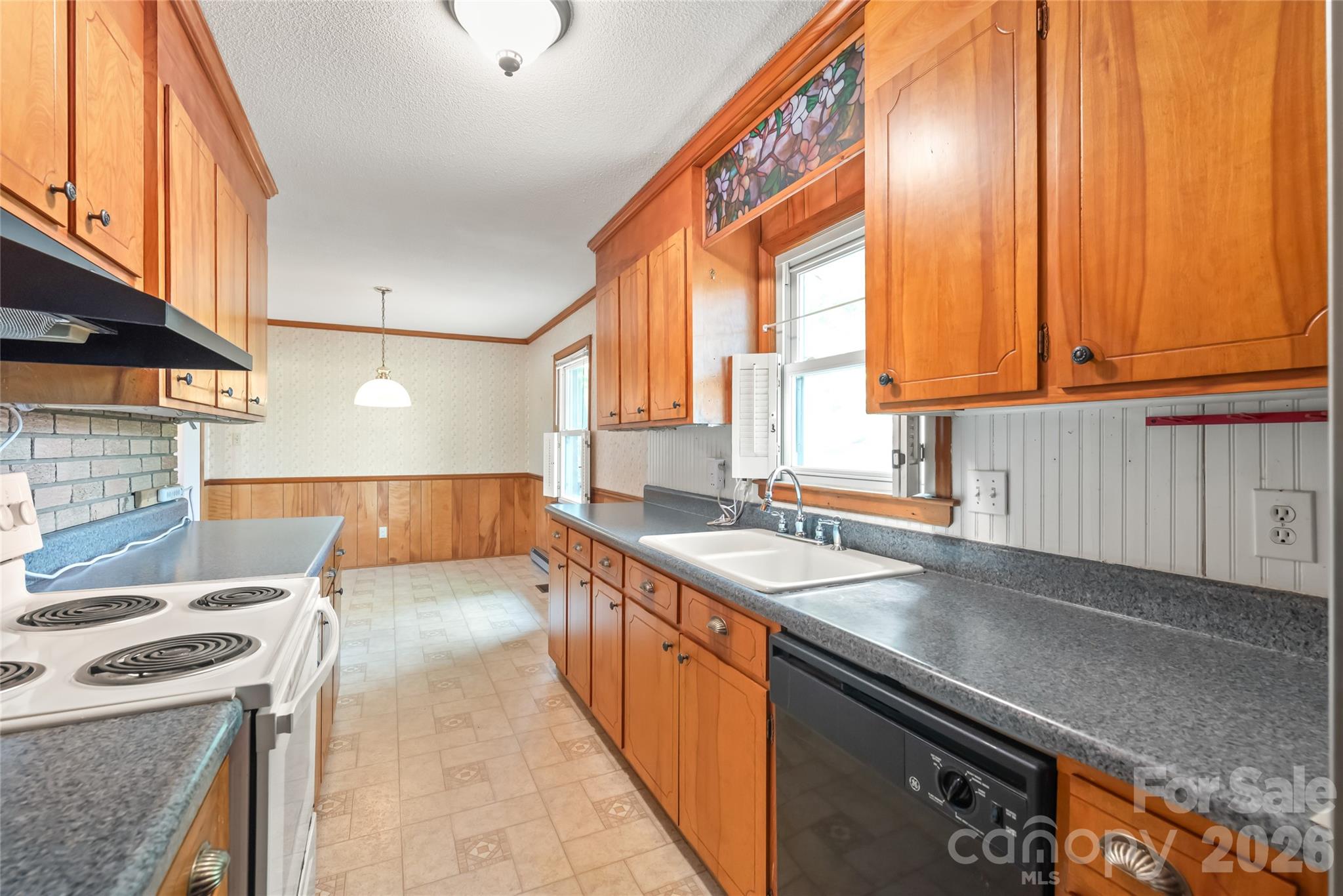 105 West Sunset Drive Locust, NC 28097 - Photo 10 of 24 a kitchen with a sink stove and cabinets