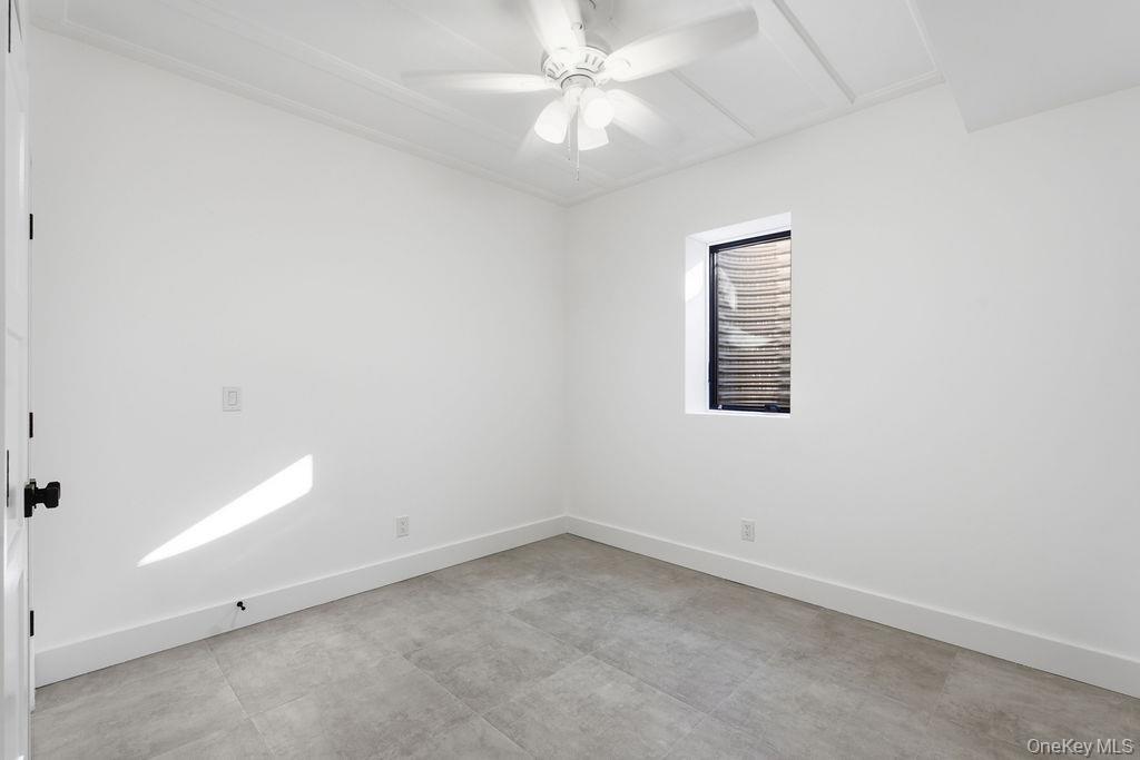 768 Bridgehampton Sag Harbor Bridgehampton, NY 11932 - Photo 11 of 35 Unfurnished room featuring baseboards and ceiling fan