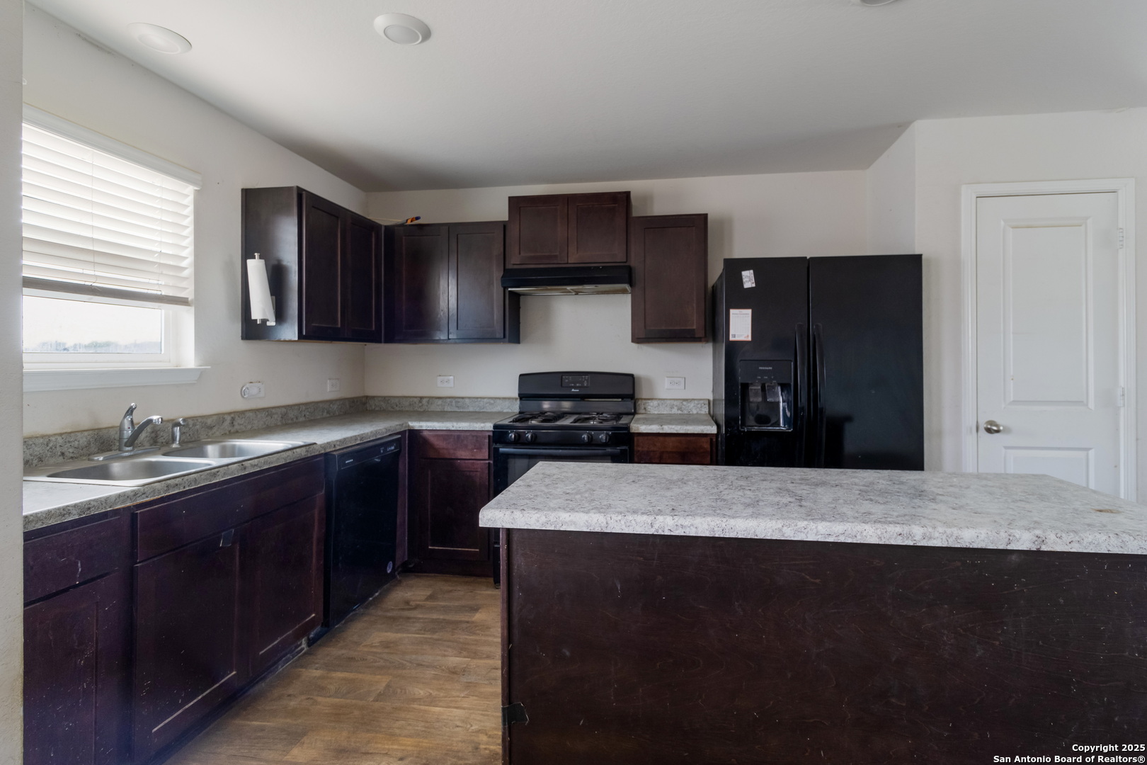 5965 Kendall Prairie Converse, TX 78109 - Photo 4 of 14 a kitchen with a sink and a refrigerator