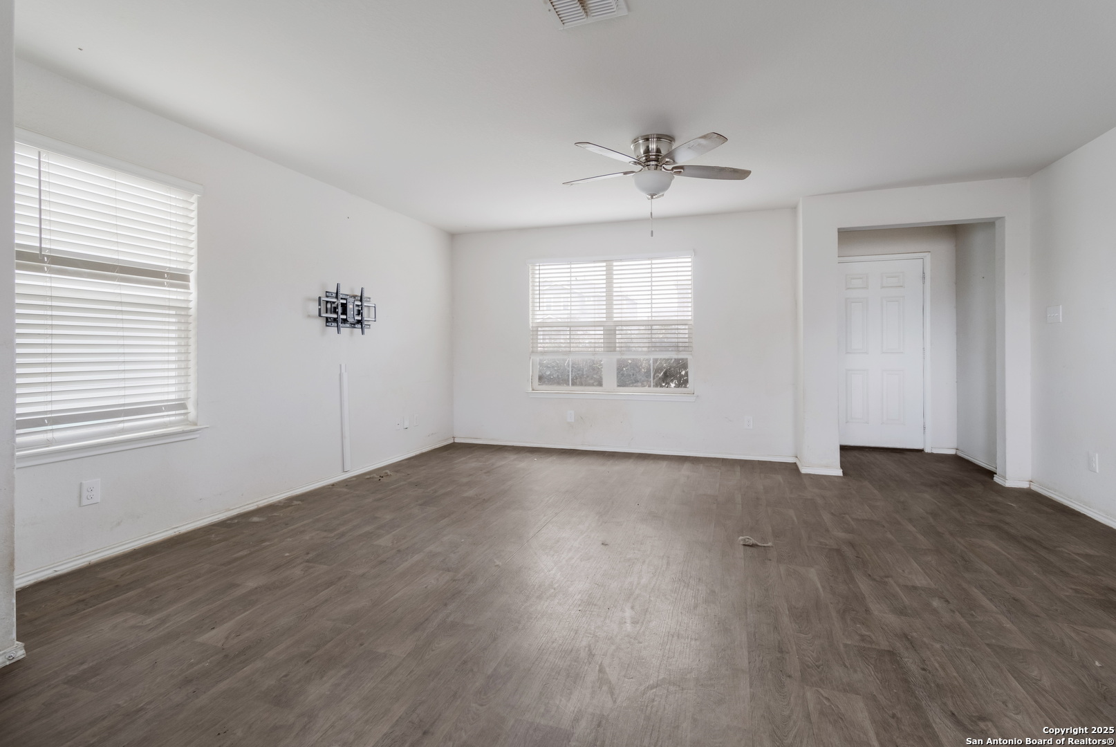 5965 Kendall Prairie Converse, TX 78109 - Photo 5 of 14 an empty room with wooden floor chandelier and windows