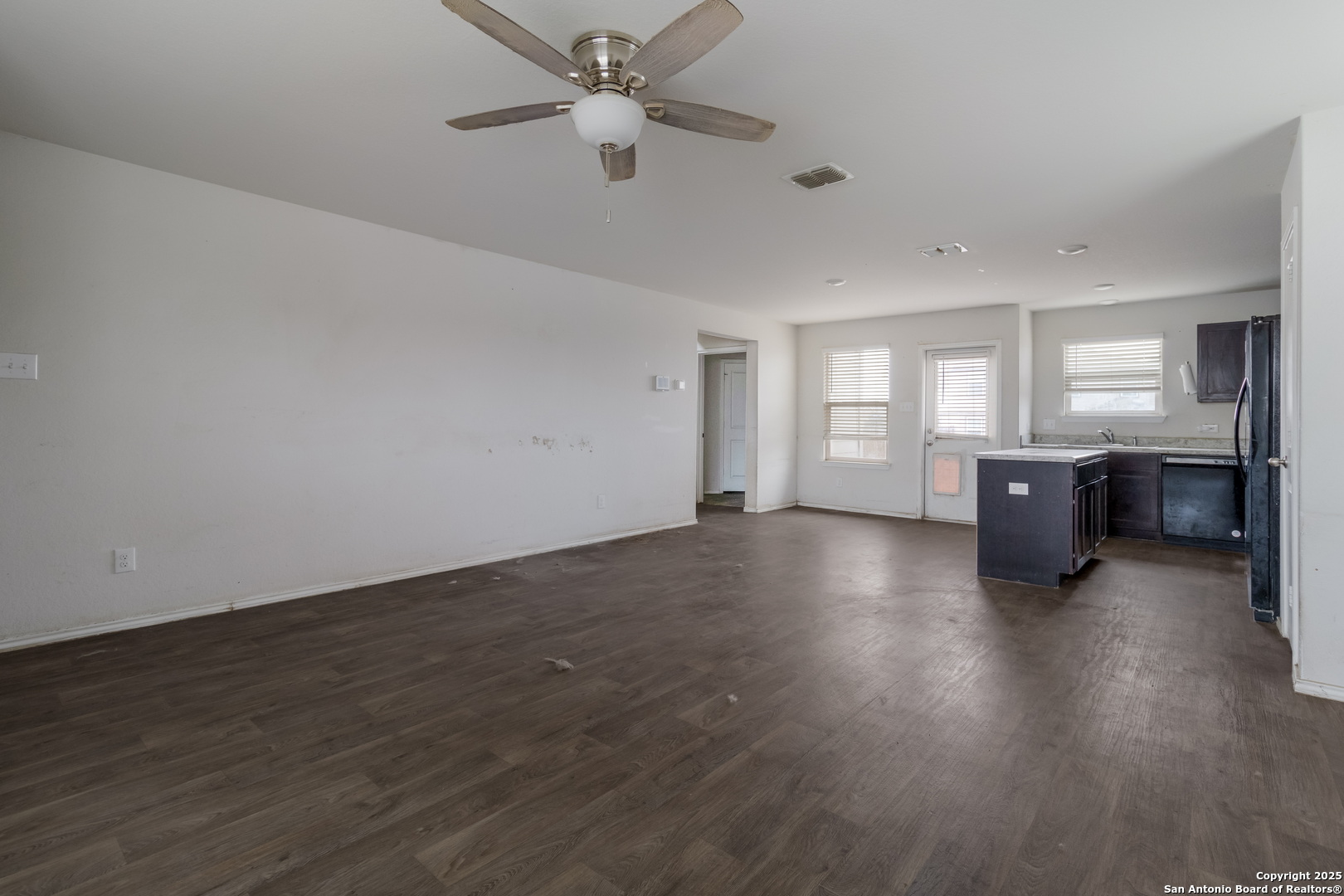 5965 Kendall Prairie Converse, TX 78109 - Photo 6 of 14 an empty room with wooden floor and windows