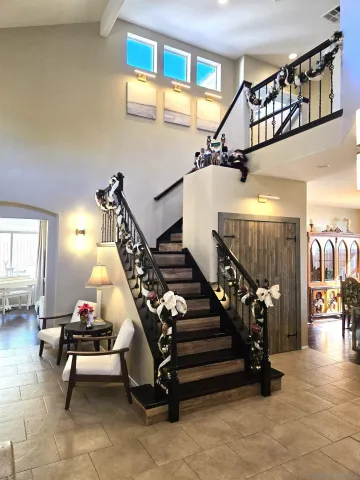 a view of a hallway with entryway and livingroom with furniture