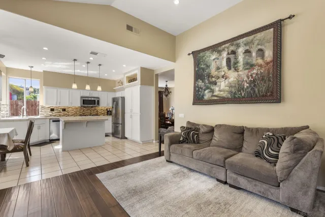 a large kitchen with kitchen island a stove a sink a table and chairs