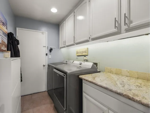 a bedroom with a bed couch and a window