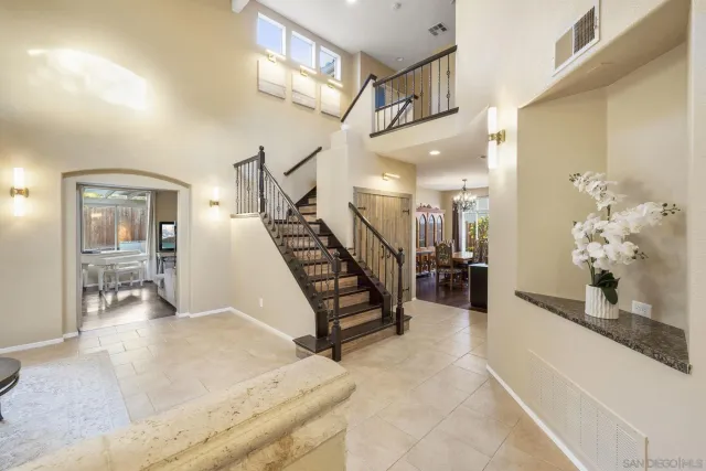 a living room with furniture and stairs